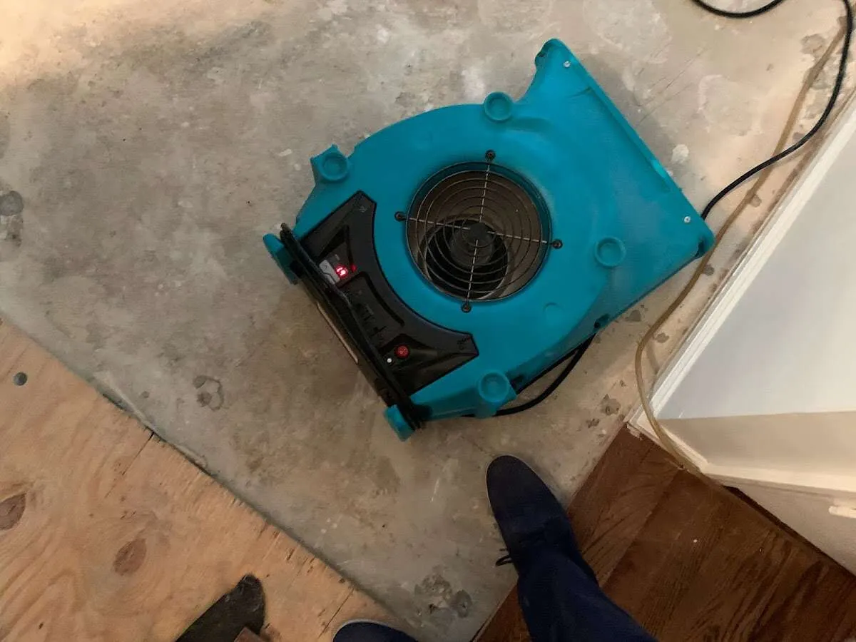 Air mover drying subfloor during Commercial Water Damage Restoration in Goleta